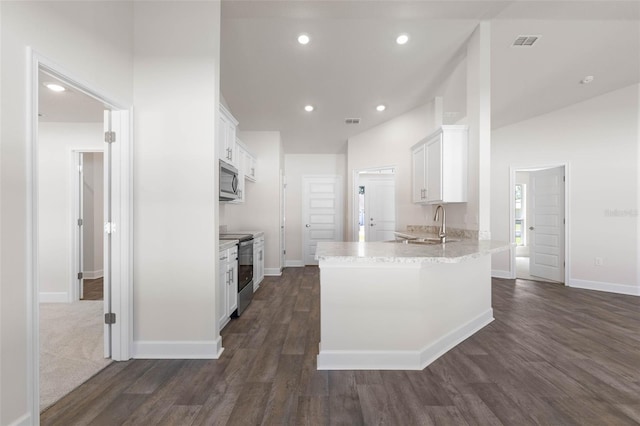 16 Service Tree Pl, Palm Coast, FL 32164 - kitchen featuring appliances with stainless steel finishes, white cabinetry, a peninsula, dark wood-style floors, and recessed lighting