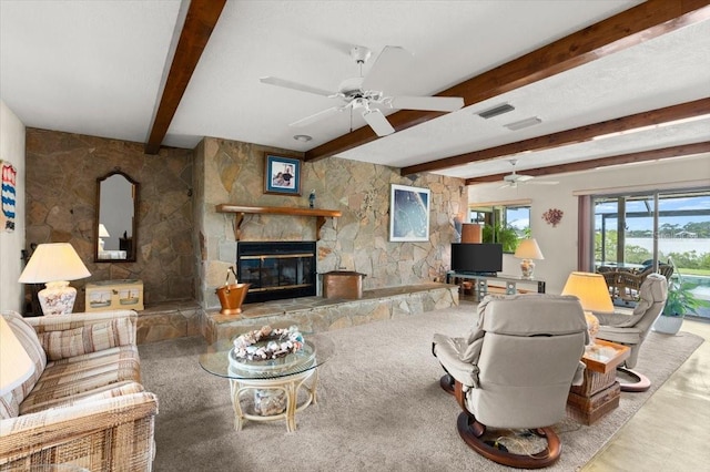 2940 Sunset Dr, New Smyrna Beach, FL 32168 - living room with beam ceiling, a stone fireplace, and ceiling fan