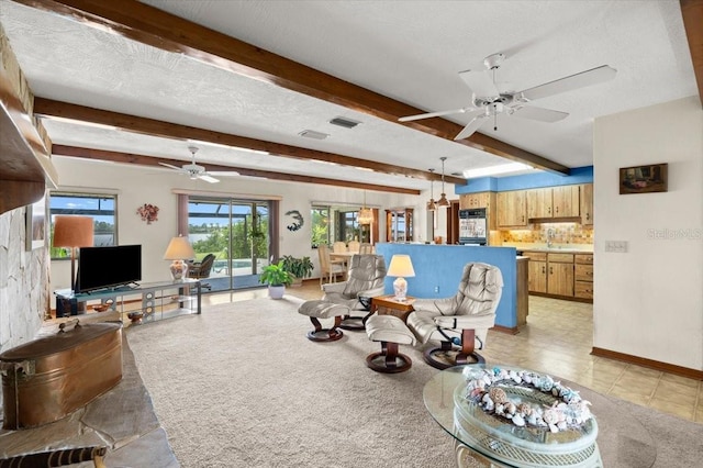 2940 Sunset Dr, New Smyrna Beach, FL 32168 - living room with a ceiling fan, beamed ceiling, and a textured ceiling