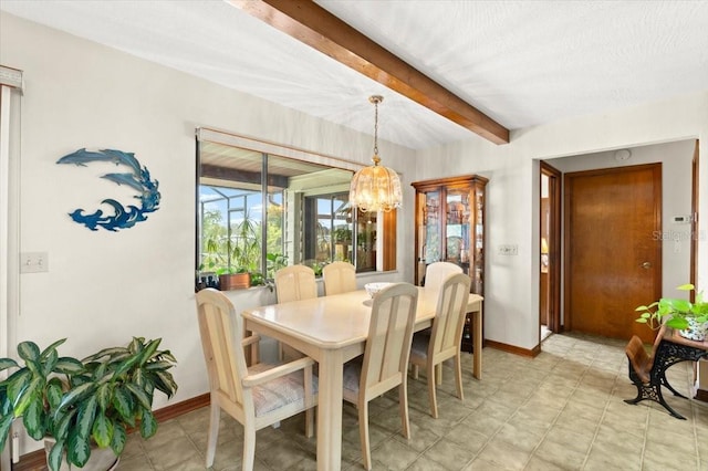 2940 Sunset Dr, New Smyrna Beach, FL 32168 - dining space with beam ceiling and a chandelier