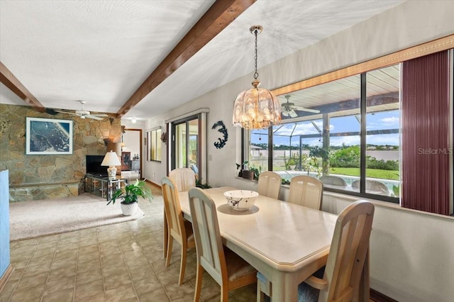 2940 Sunset Dr, New Smyrna Beach, FL 32168 - dining space featuring ceiling fan, beam ceiling, and a sunroom