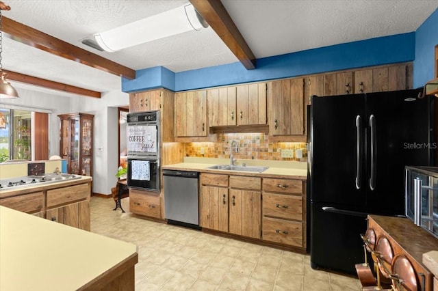 2940 Sunset Dr, New Smyrna Beach, FL 32168 - kitchen with black appliances, beam ceiling, backsplash, light countertops, and a textured ceiling