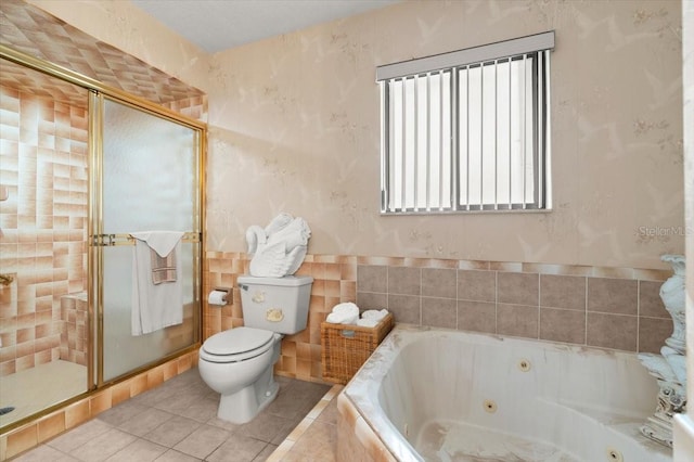 2940 Sunset Dr, New Smyrna Beach, FL 32168 - bathroom featuring a jetted tub, a stall shower, and tile patterned floors