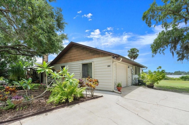 2940 Sunset Dr, New Smyrna Beach, FL 32168 - view of side of home with driveway and a garage