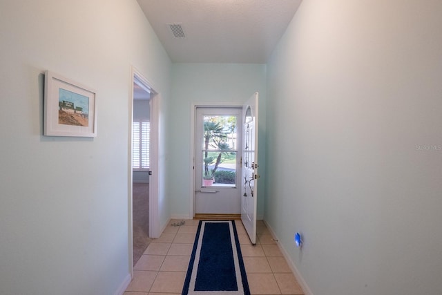 47 Summerwind Cir, Palm Coast, FL 32137 - doorway with light tile patterned floors and baseboards