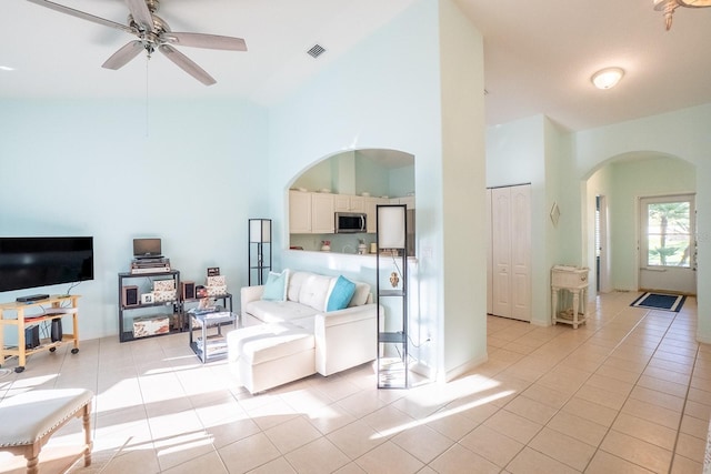 47 Summerwind Cir, Palm Coast, FL 32137 - living area featuring arched walkways, light tile patterned floors, high vaulted ceiling, and a ceiling fan