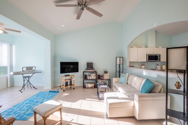 47 Summerwind Cir, Palm Coast, FL 32137 - living room with a ceiling fan, high vaulted ceiling, light tile patterned floors, and arched walkways
