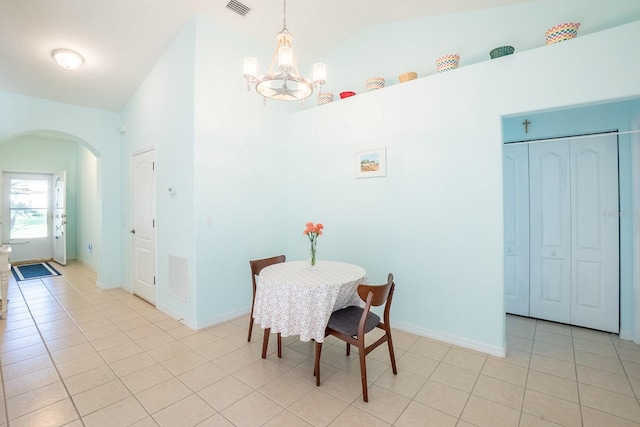 47 Summerwind Cir, Palm Coast, FL 32137 - dining room with arched walkways, a chandelier, light tile patterned floors, and high vaulted ceiling