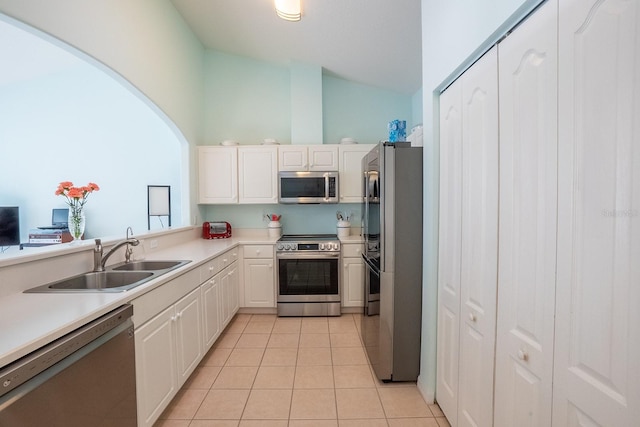 47 Summerwind Cir, Palm Coast, FL 32137 - kitchen featuring stainless steel appliances, light tile patterned flooring, light countertops, white cabinetry, and high vaulted ceiling