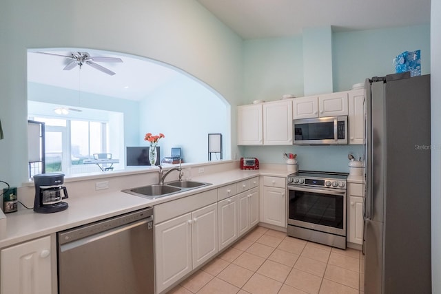47 Summerwind Cir, Palm Coast, FL 32137 - kitchen with appliances with stainless steel finishes, light tile patterned floors, white cabinets, a ceiling fan, and light countertops