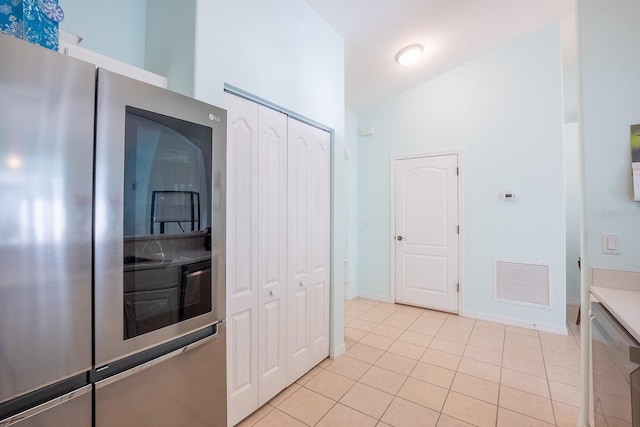 47 Summerwind Cir, Palm Coast, FL 32137 - kitchen with smart refrigerator and light tile patterned flooring