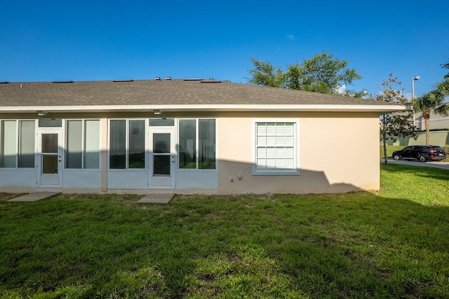 47 Summerwind Cir, Palm Coast, FL 32137 - back of property featuring a lawn and stucco siding