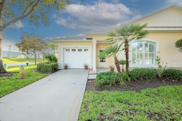 47 Summerwind Cir, Palm Coast, FL 32137 - view of front of house with stucco siding, concrete driveway, and an attached garage