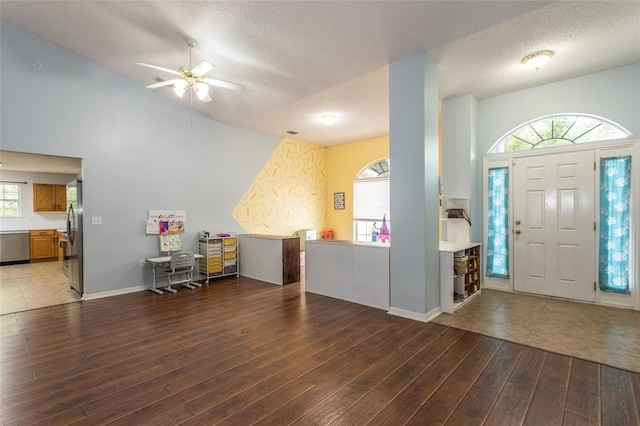 32 Karas Trl, Palm Coast, FL 32164 - entryway with a textured ceiling, vaulted ceiling, light wood-style floors, ceiling fan, and plenty of natural light
