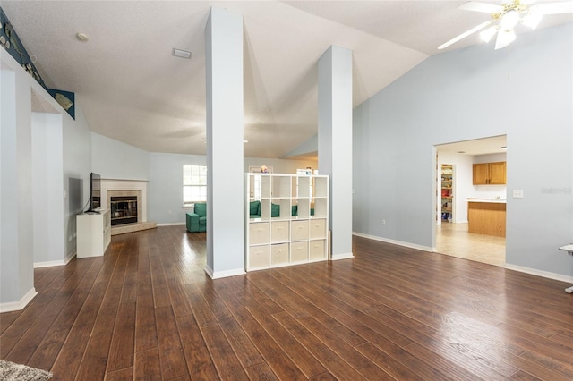 32 Karas Trl, Palm Coast, FL 32164 - unfurnished living room featuring a ceiling fan, wood finished floors, a fireplace, and high vaulted ceiling