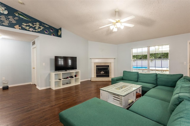 32 Karas Trl, Palm Coast, FL 32164 - living area featuring a textured ceiling, wood finished floors, a ceiling fan, lofted ceiling, and a tiled fireplace