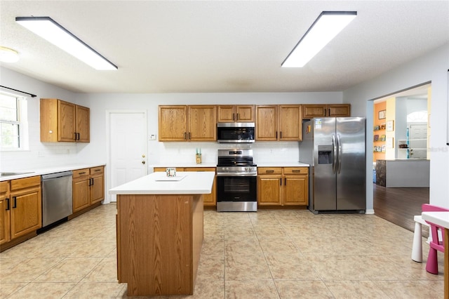 32 Karas Trl, Palm Coast, FL 32164 - kitchen with appliances with stainless steel finishes, brown cabinets, backsplash, and light countertops