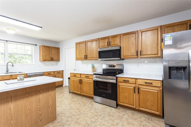 32 Karas Trl, Palm Coast, FL 32164 - kitchen featuring stainless steel appliances, decorative backsplash, light countertops, brown cabinets, and a textured ceiling