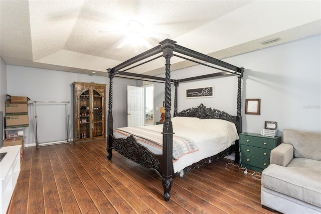 32 Karas Trl, Palm Coast, FL 32164 - bedroom with wood finished floors, a raised ceiling, a ceiling fan, and a textured ceiling