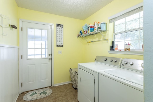 32 Karas Trl, Palm Coast, FL 32164 - washroom featuring washing machine and dryer, healthy amount of natural light, a textured ceiling, and light tile patterned floors