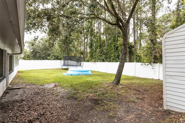 32 Karas Trl, Palm Coast, FL 32164 - fenced backyard with a trampoline