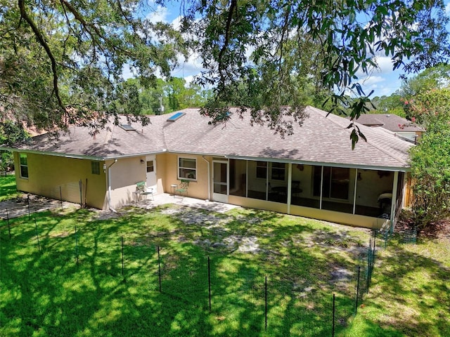 5 Wilksboro Pl, Palm Coast, FL 32164 - back of house featuring a sunroom, a shingled roof, a yard, and stucco siding