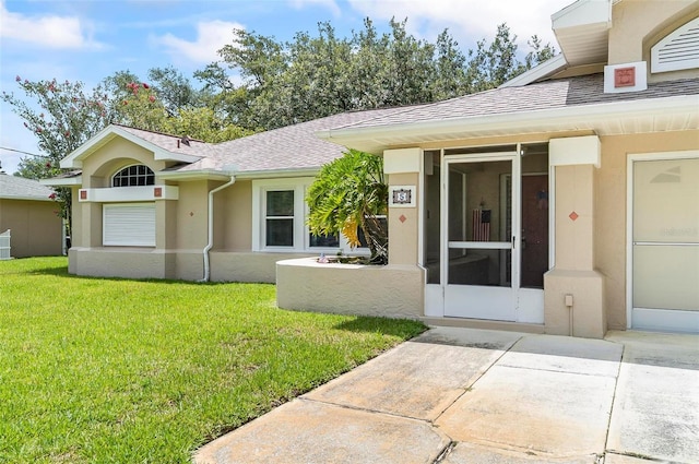 5 Wilksboro Pl, Palm Coast, FL 32164 - view of front facade with a front lawn, stucco siding, and roof with shingles