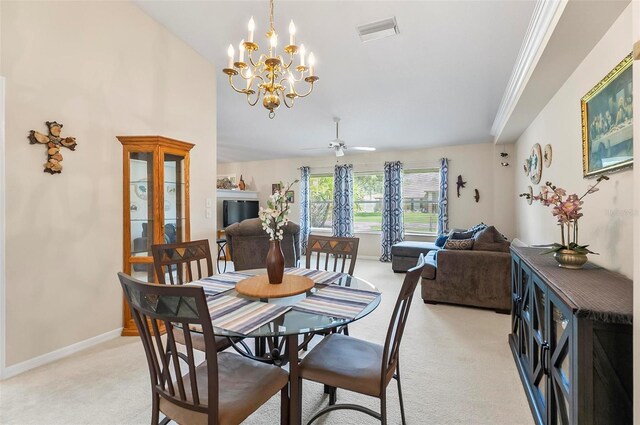 5 Wilksboro Pl, Palm Coast, FL 32164 - dining area with light colored carpet, a chandelier, vaulted ceiling, and a ceiling fan