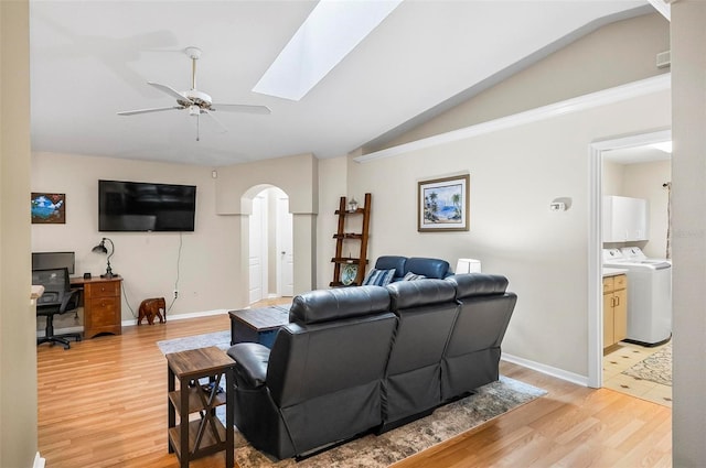 5 Wilksboro Pl, Palm Coast, FL 32164 - living room with washer / dryer, arched walkways, vaulted ceiling, a ceiling fan, and light wood-style flooring