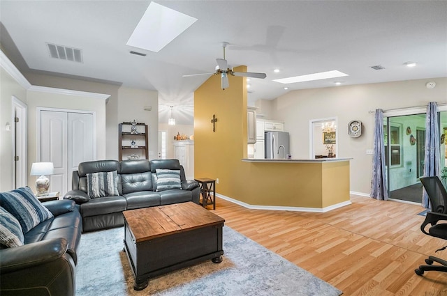 5 Wilksboro Pl, Palm Coast, FL 32164 - living room featuring a skylight, light wood-style floors, ceiling fan, vaulted ceiling, and recessed lighting