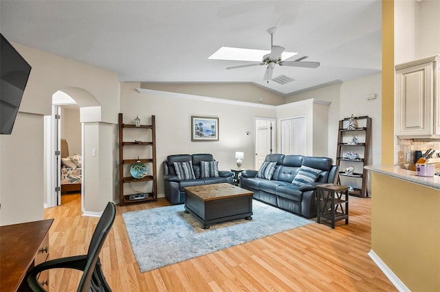 5 Wilksboro Pl, Palm Coast, FL 32164 - living area featuring a ceiling fan, lofted ceiling, light wood-style floors, and arched walkways