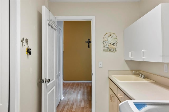 5 Wilksboro Pl, Palm Coast, FL 32164 - laundry room featuring cabinet space and light wood-type flooring