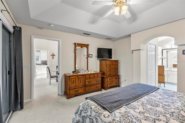 5 Wilksboro Pl, Palm Coast, FL 32164 - bedroom with arched walkways, light colored carpet, a raised ceiling, and ceiling fan