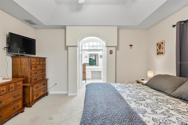 5 Wilksboro Pl, Palm Coast, FL 32164 - bedroom with light carpet, a raised ceiling, ensuite bath, and ceiling fan