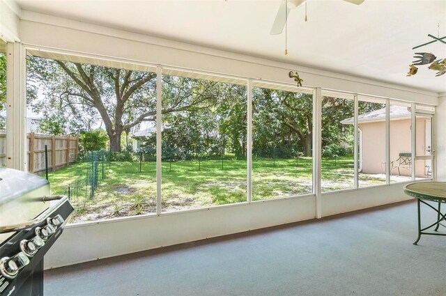 5 Wilksboro Pl, Palm Coast, FL 32164 - unfurnished sunroom featuring a ceiling fan and carpet floors