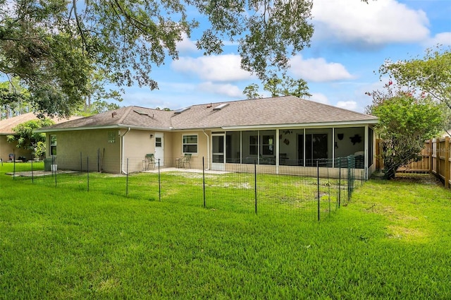 5 Wilksboro Pl, Palm Coast, FL 32164 - rear view of house with a sunroom, a fenced backyard, stucco siding, and roof with shingles