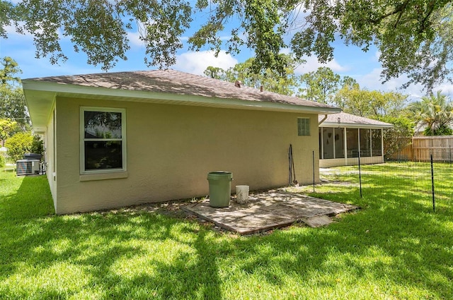 5 Wilksboro Pl, Palm Coast, FL 32164 - back of house with stucco siding, a sunroom, and a shingled roof