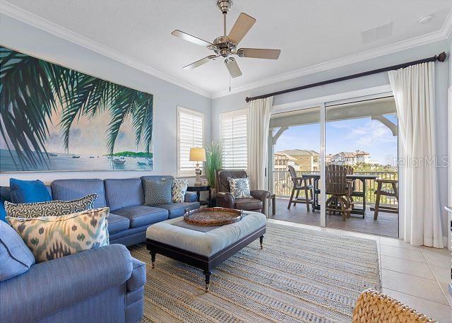 200 Cinnamon Beach Way Unit 131, Palm Coast, FL 32137 - living room with ceiling fan, light tile patterned floors, and crown molding