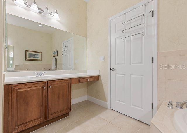 200 Cinnamon Beach Way Unit 131, Palm Coast, FL 32137 - bathroom with vanity, tile patterned floors, and a bath