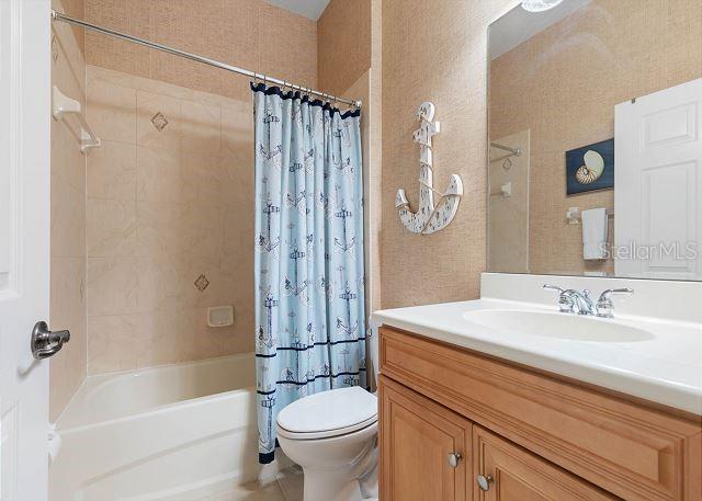 200 Cinnamon Beach Way Unit 131, Palm Coast, FL 32137 - bathroom with shower / bath combination with curtain and vanity