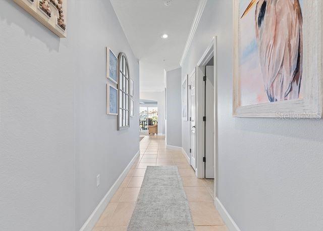 200 Cinnamon Beach Way Unit 131, Palm Coast, FL 32137 - hall with light tile patterned flooring, crown molding, and recessed lighting