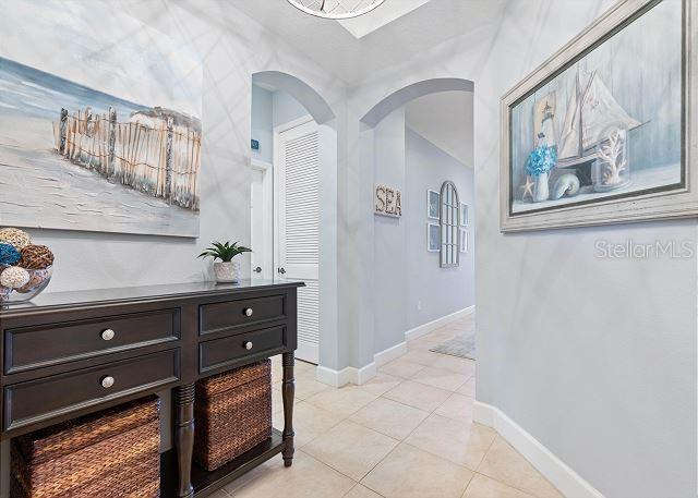 200 Cinnamon Beach Way Unit 131, Palm Coast, FL 32137 - corridor featuring arched walkways and light tile patterned floors