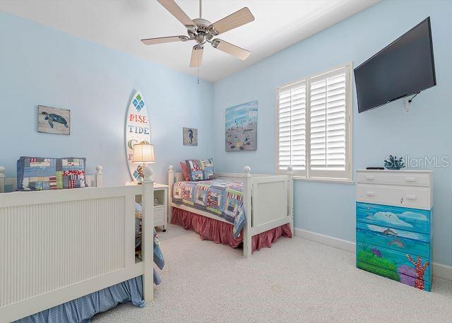 200 Cinnamon Beach Way Unit 131, Palm Coast, FL 32137 - carpeted bedroom featuring baseboards and ceiling fan