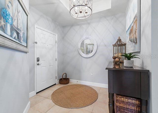 200 Cinnamon Beach Way Unit 131, Palm Coast, FL 32137 - foyer entrance featuring a chandelier and light tile patterned floors