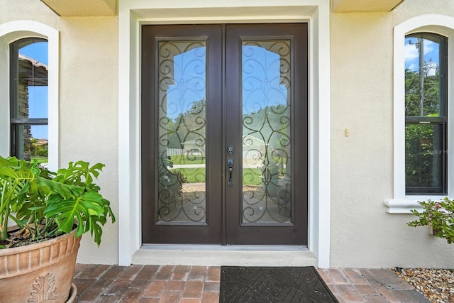 42 Felwood Ln, Palm Coast, FL 32137 - doorway to property with french doors and stucco siding