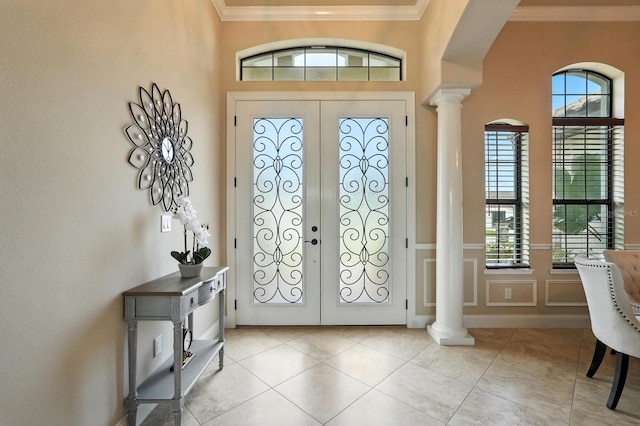 42 Felwood Ln, Palm Coast, FL 32137 - foyer entrance with french doors, decorative columns, ornamental molding, light tile patterned flooring, and a decorative wall
