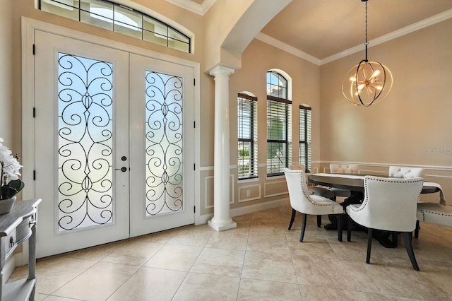 42 Felwood Ln, Palm Coast, FL 32137 - foyer entrance featuring ornamental molding, arched walkways, decorative columns, a chandelier, and a decorative wall
