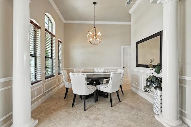 42 Felwood Ln, Palm Coast, FL 32137 - dining space featuring ornate columns, a decorative wall, ornamental molding, a chandelier, and wainscoting