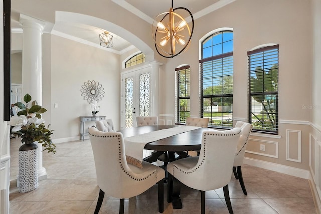 42 Felwood Ln, Palm Coast, FL 32137 - dining room with healthy amount of natural light, crown molding, a chandelier, decorative columns, and light tile patterned floors