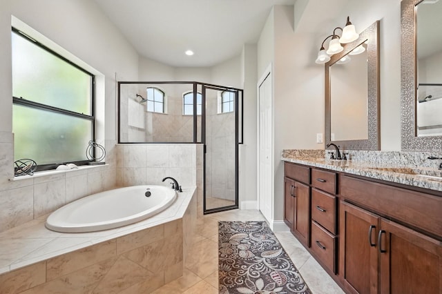 42 Felwood Ln, Palm Coast, FL 32137 - bathroom with a bath, double vanity, a stall shower, and tile patterned floors